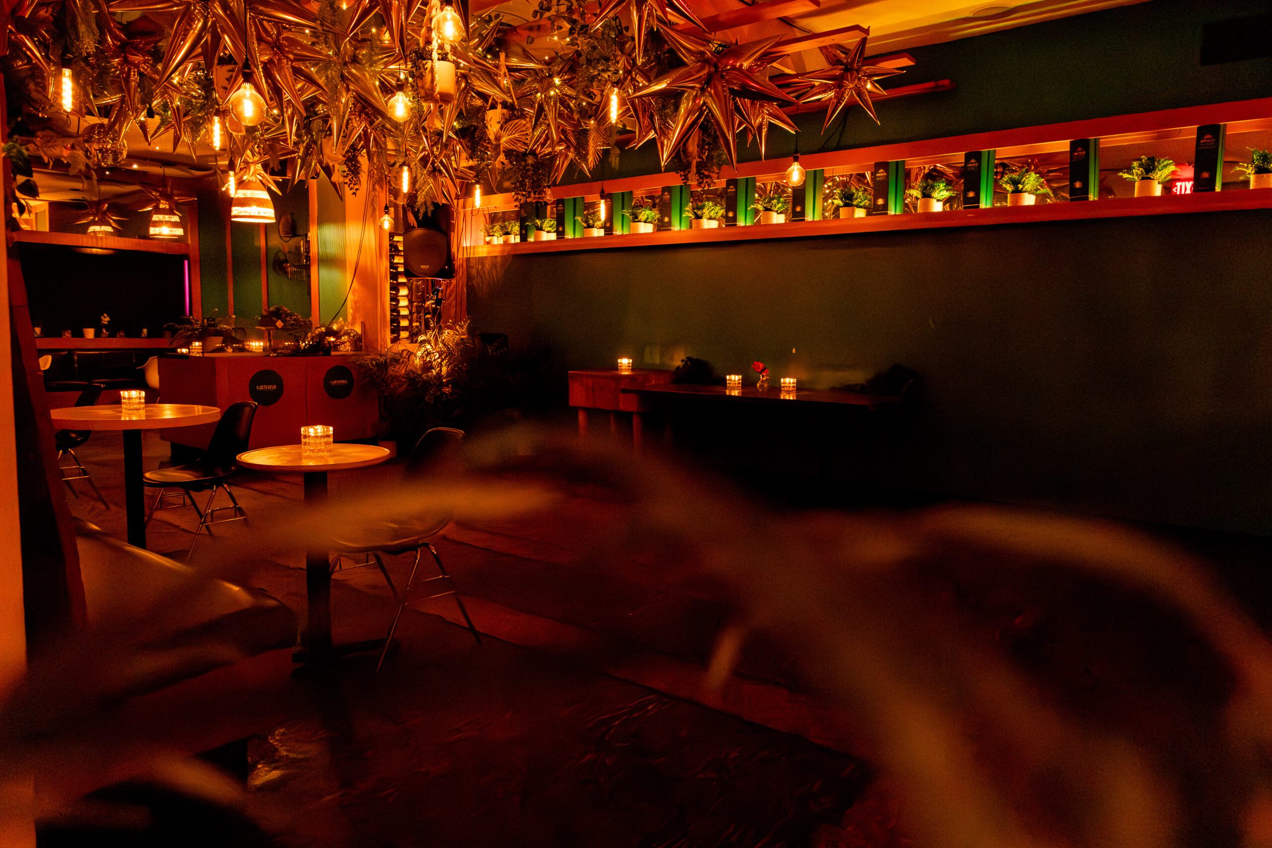 Candlelit tables, hanging ceiling lamps, and balloons highlight The Loft at Pawn Shop YVR, a vibrant event space in Vancouver.