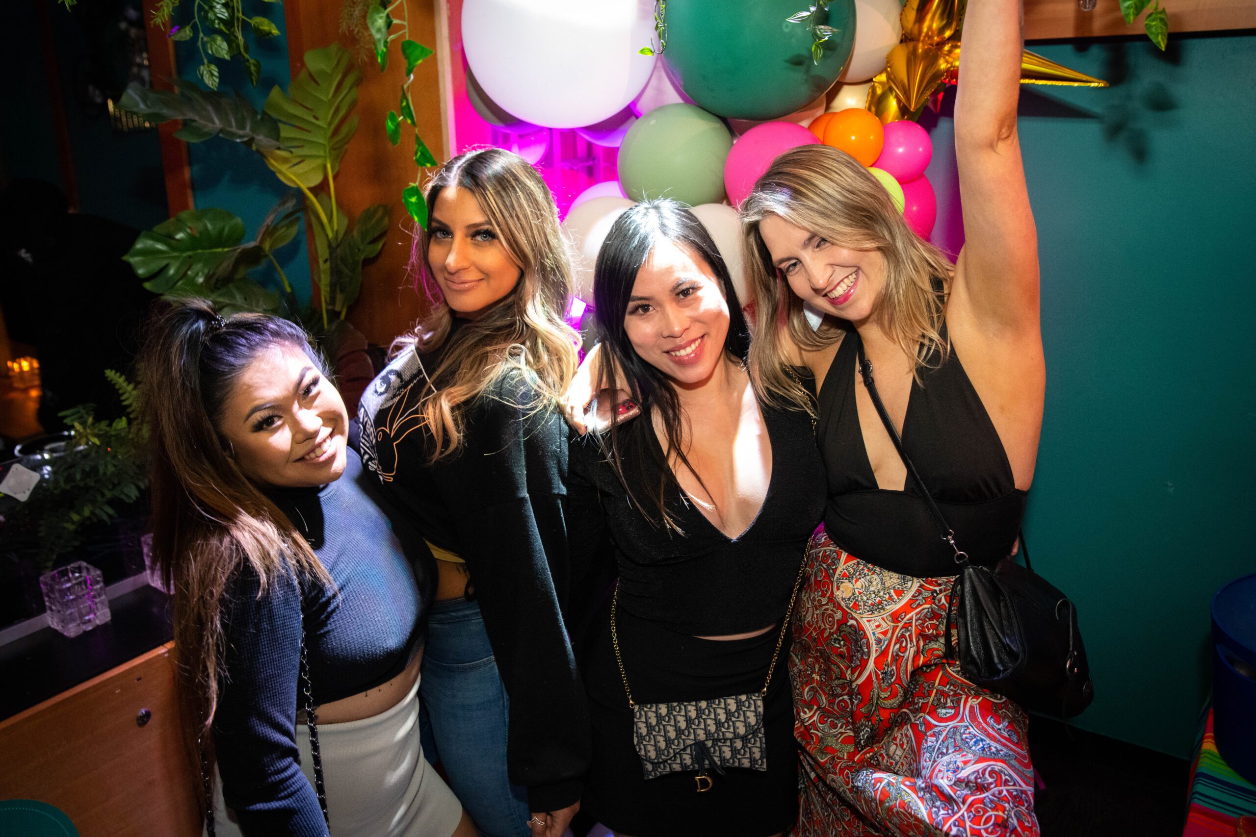 Four women smiling at a private events space at Pawn Shop YVR on Granville Street in downtown Vancouver.
