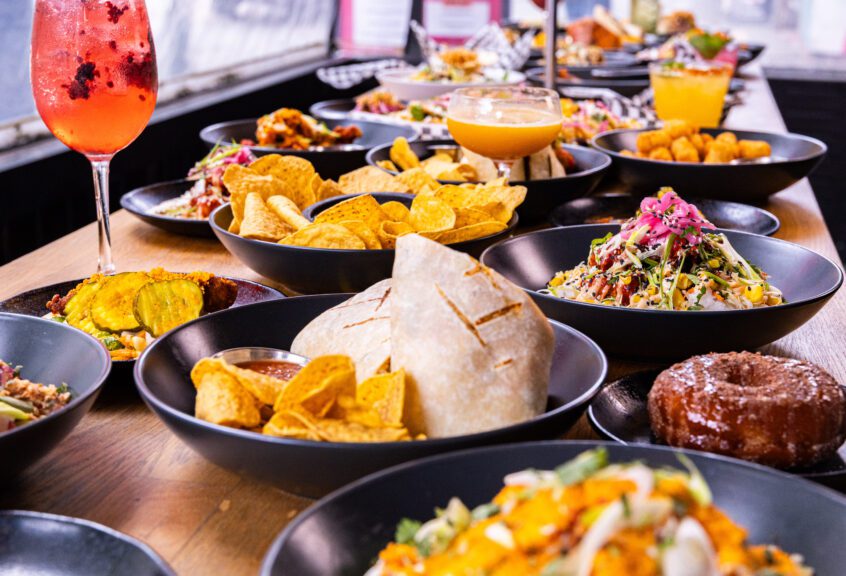 A vibrant collection of new menu items at The Pawn Shop YVR, showcasing brand new items including burritos, rice bowls, tacos, and signature cocktails.