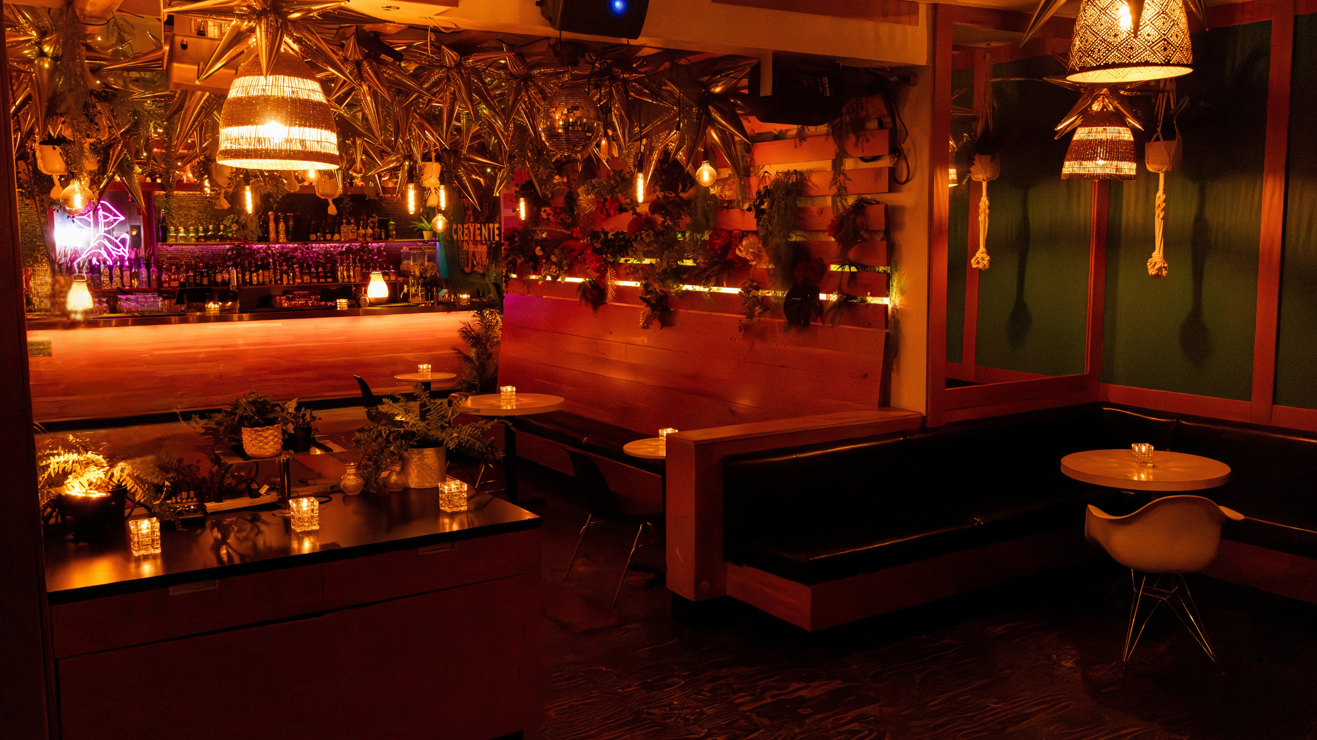 The Loft at Pawn Shop YVR, a unique event space in Vancouver. Dim lighting, candles, bar, and vintage neon sign set a cool mood.