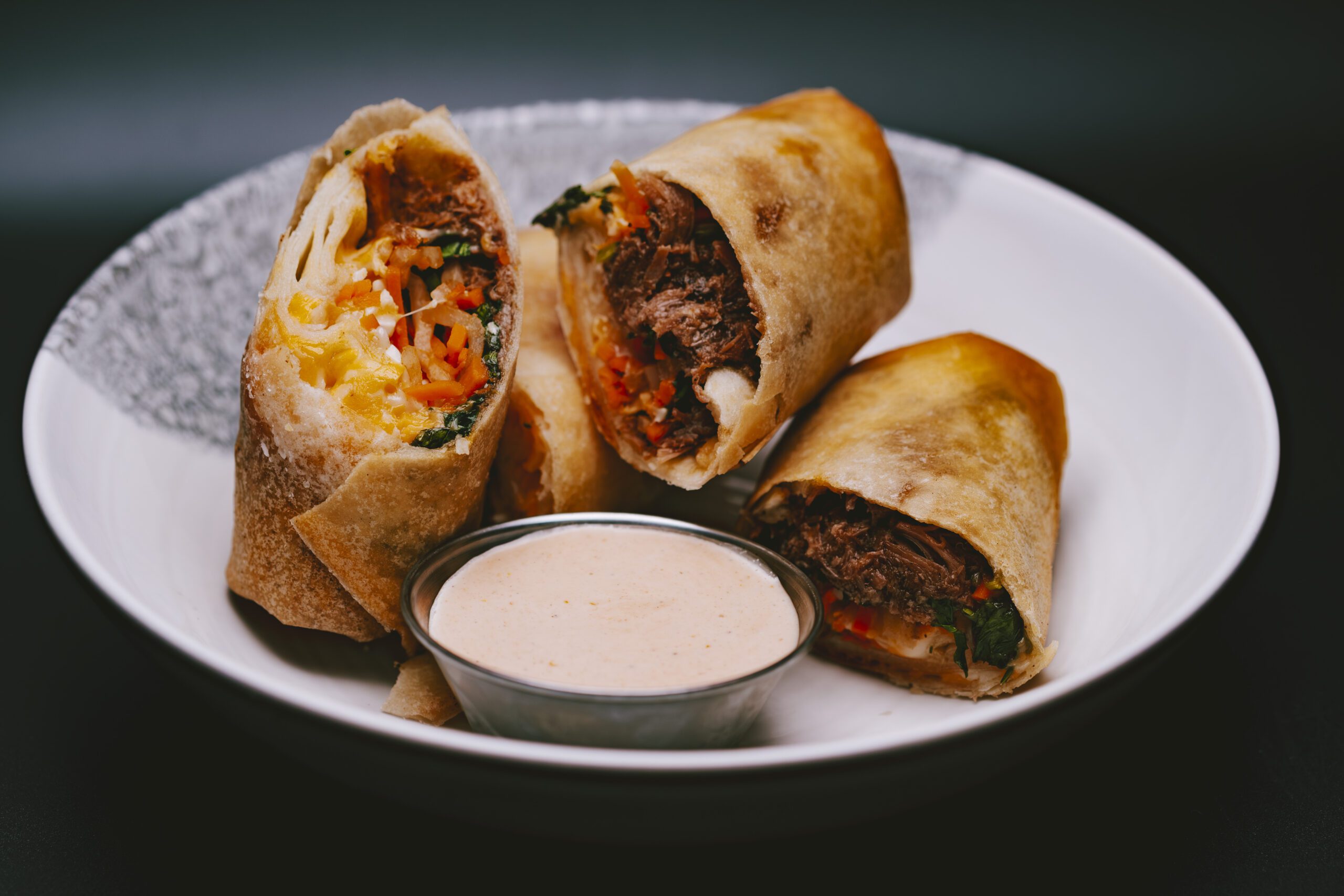 Close-up of the Beef Birria Spring Rolls, a unique new item at The Pawn Shop YVR